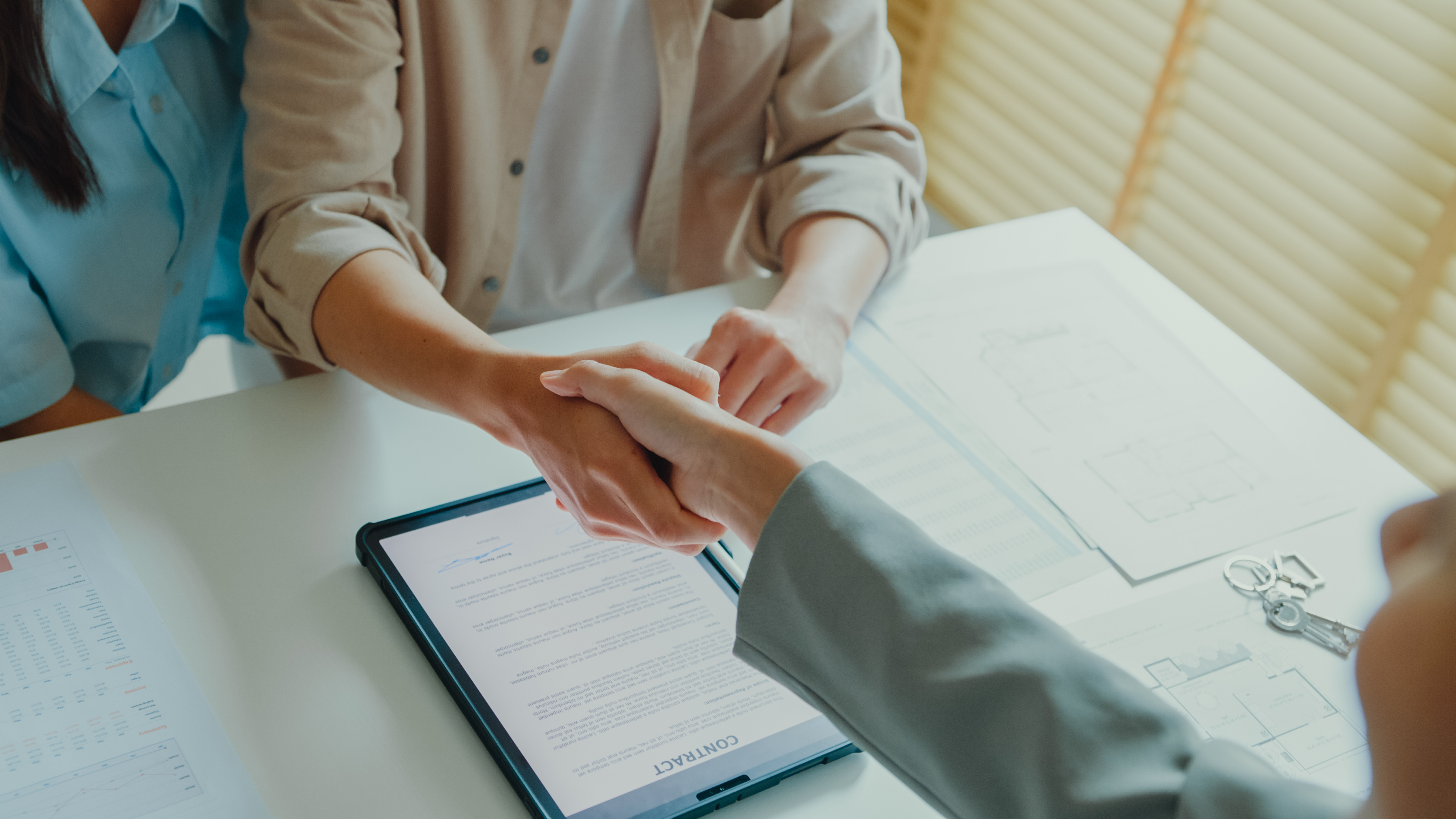 people%20shaking%20hands%20across%20a%20desk%20with%20a%20contract%20on%20it people%20shaking%20hands%20across%20a%20desk%20with%20a%20contract%20on%20it